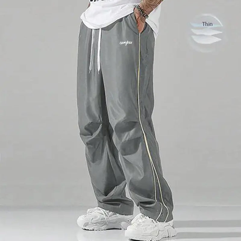 Elevate Your Style with Men's Summer Loose Sports Pants - Lightweight, Comfortable, and Stylish Gray Trousers with Gold Accents